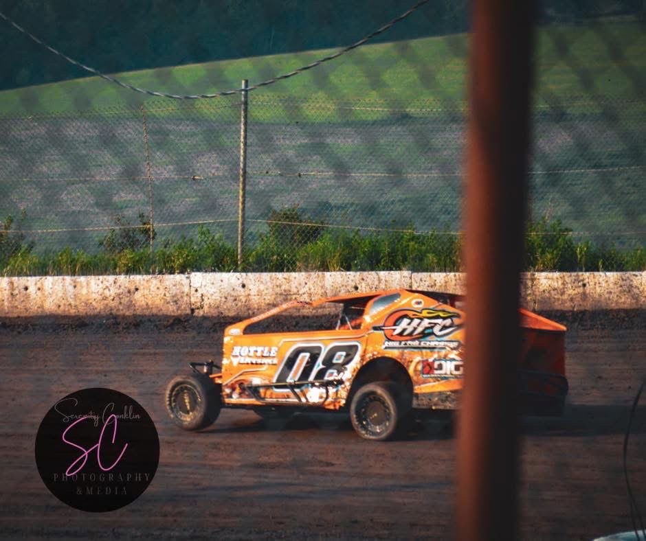 Orange number 08 modified car ripping through the corner